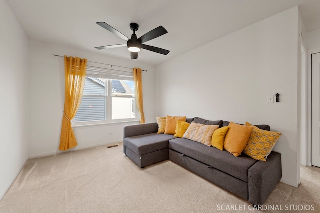 living room featuring light carpet and ceiling fan