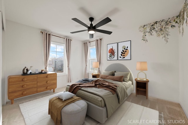 bedroom featuring ceiling fan and light colored carpet