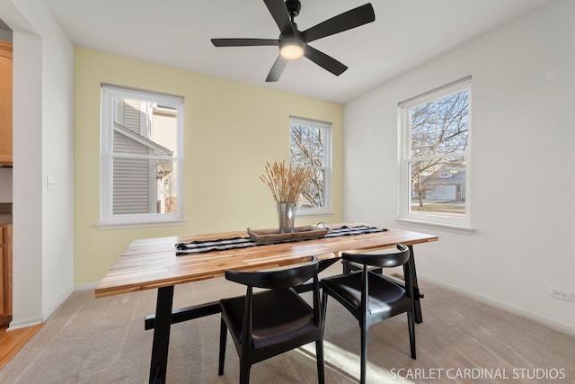 carpeted dining space featuring ceiling fan