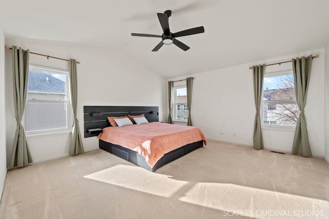 bedroom with ceiling fan, light carpet, and lofted ceiling