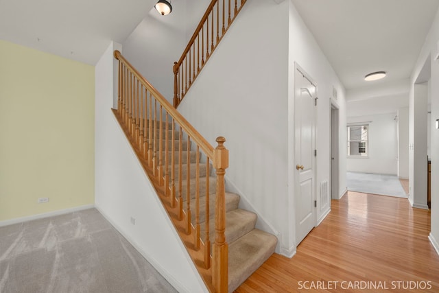 stairs with hardwood / wood-style flooring