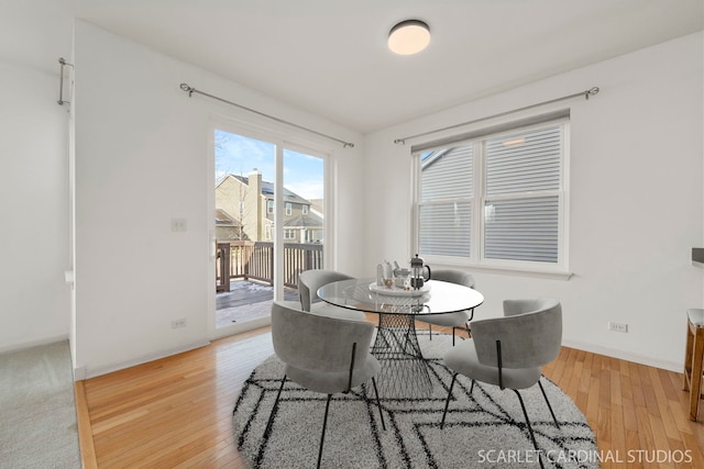 dining space with light hardwood / wood-style flooring