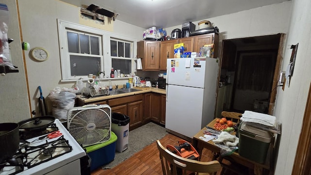 kitchen featuring white appliances and sink