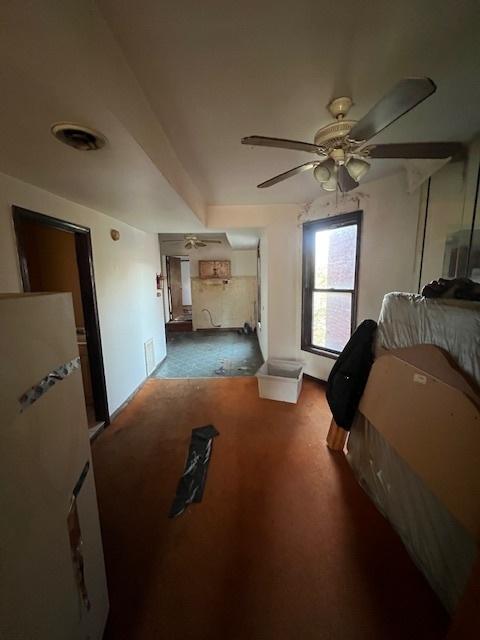 bedroom with ceiling fan and dark carpet