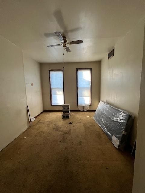 spare room with carpet and ceiling fan