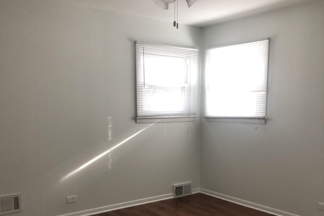 empty room featuring dark hardwood / wood-style floors and ceiling fan