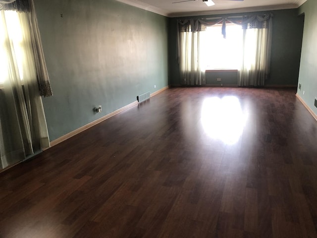 spare room with ceiling fan, dark hardwood / wood-style flooring, and ornamental molding