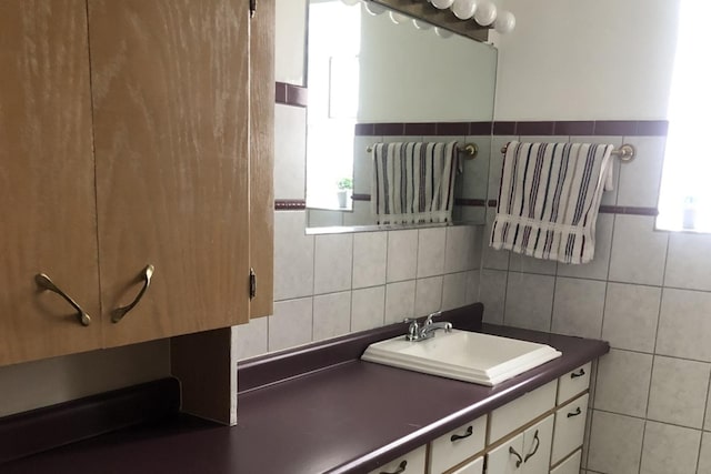 bathroom with tasteful backsplash, radiator, vanity, and tile walls