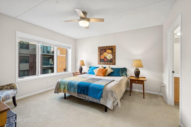 carpeted bedroom with ceiling fan and ensuite bathroom