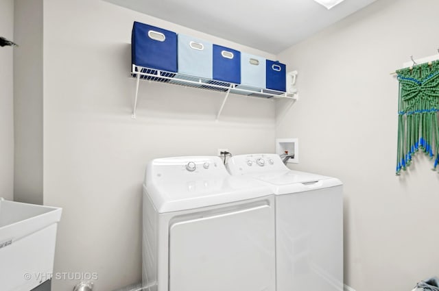 washroom with sink and washing machine and clothes dryer