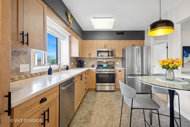 kitchen with decorative backsplash, light brown cabinets, sink, and stainless steel appliances