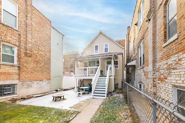 back of property with an outdoor fire pit