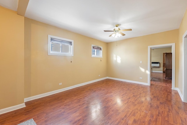 empty room with ceiling fan and wood-type flooring