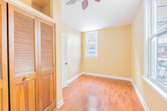 unfurnished bedroom with ceiling fan and light hardwood / wood-style flooring