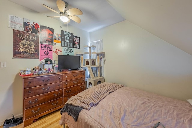 bedroom with hardwood / wood-style flooring and lofted ceiling