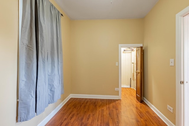 spare room with wood-type flooring