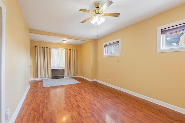 unfurnished living room featuring hardwood / wood-style flooring, plenty of natural light, and ceiling fan