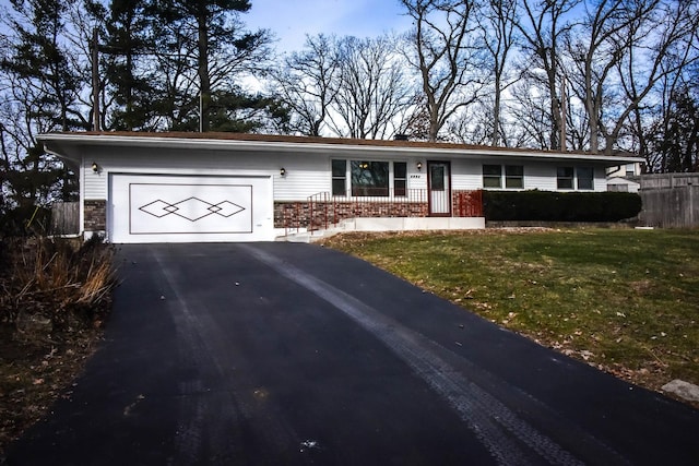 single story home featuring a front yard and a garage