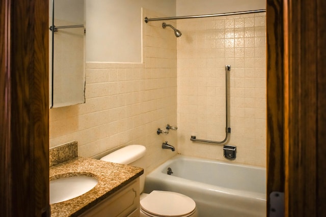 full bathroom featuring tile walls, vanity,  shower combination, and toilet