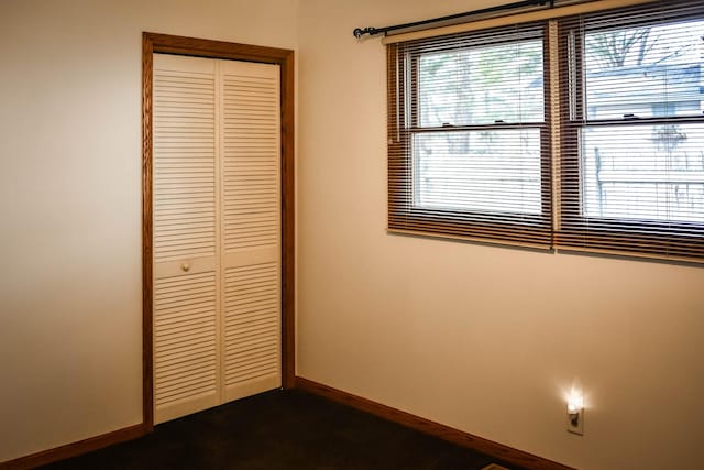 unfurnished bedroom with a closet and carpet floors