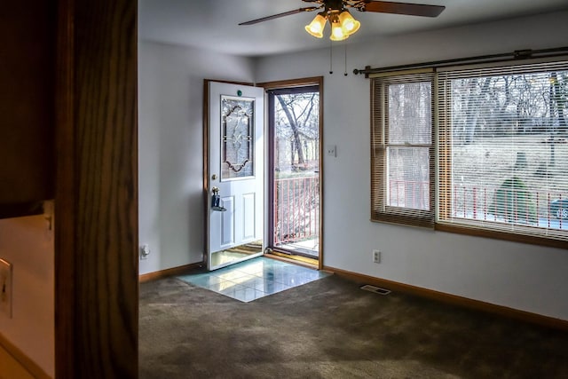 foyer with carpet floors and ceiling fan