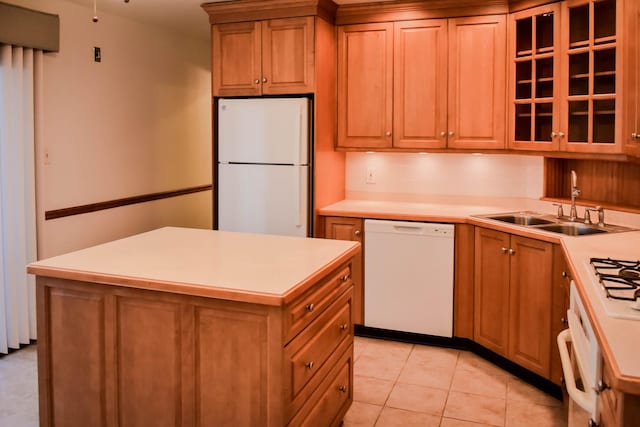 kitchen with tasteful backsplash, white appliances, sink, light tile patterned floors, and a center island