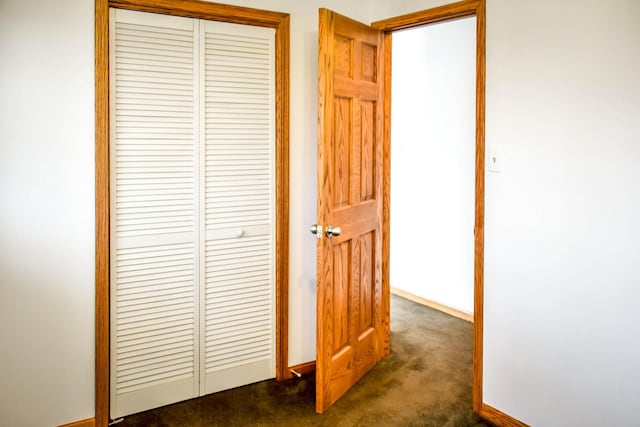 corridor with dark colored carpet