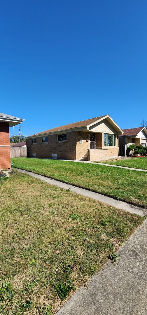 view of side of home with a lawn