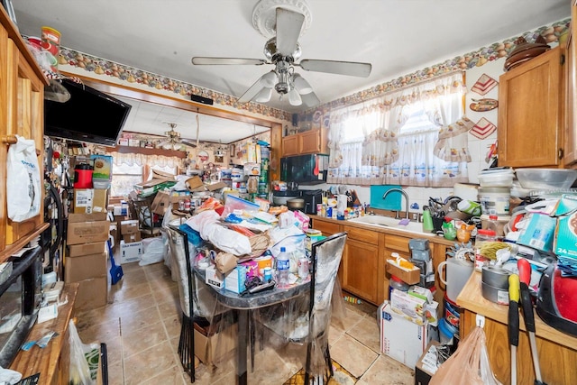 kitchen featuring light tile patterned flooring, ceiling fan, and sink