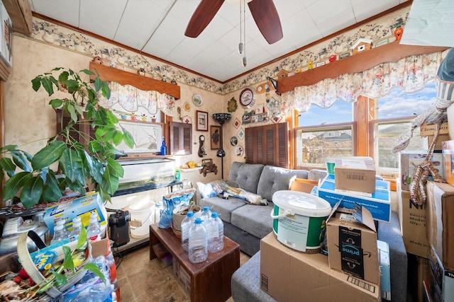 interior space featuring ceiling fan and ornamental molding