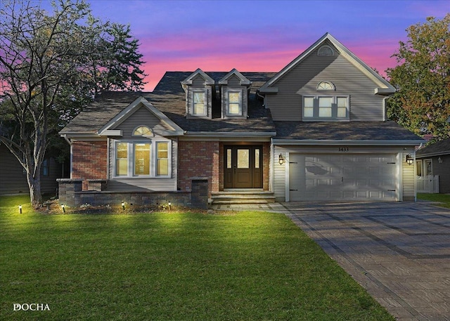 view of front of house with a lawn and a garage