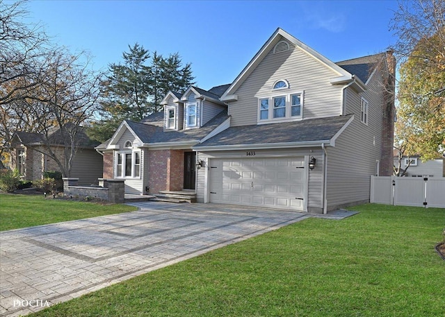 view of front of property with a front yard and a garage