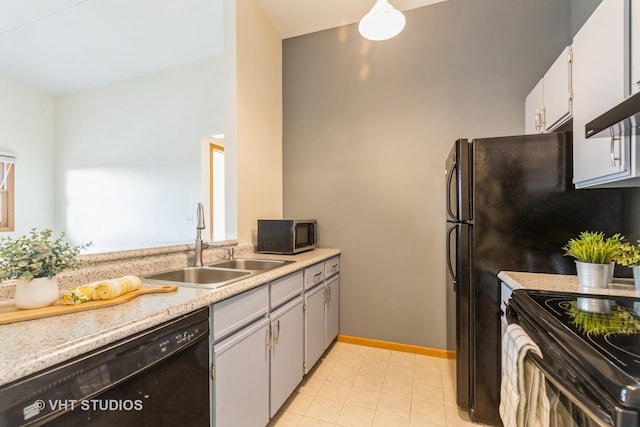 kitchen featuring white cabinets, light tile patterned floors, sink, and black appliances