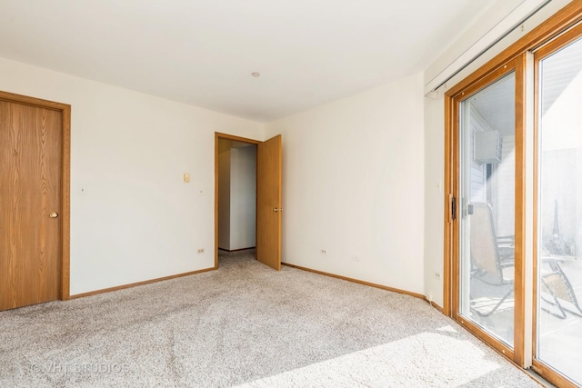 unfurnished bedroom featuring access to exterior and light colored carpet