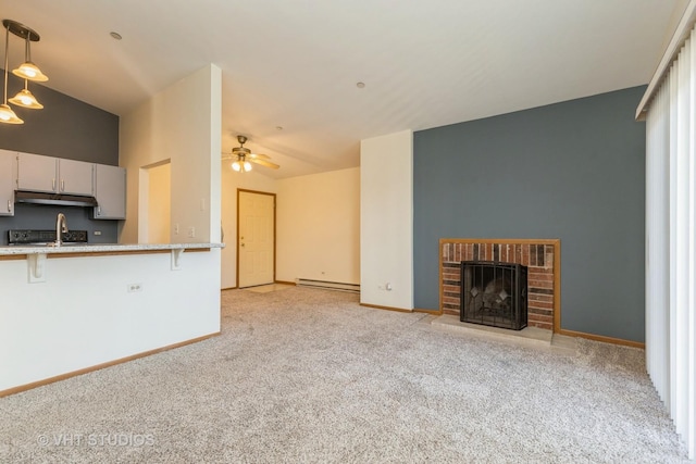 unfurnished living room featuring a fireplace, light carpet, ceiling fan, and a baseboard heating unit