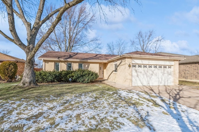 single story home featuring a garage and a lawn