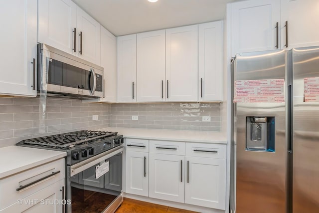 kitchen with white cabinetry, decorative backsplash, and stainless steel appliances