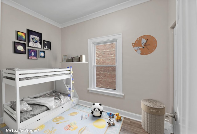 bedroom featuring ornamental molding and hardwood / wood-style flooring