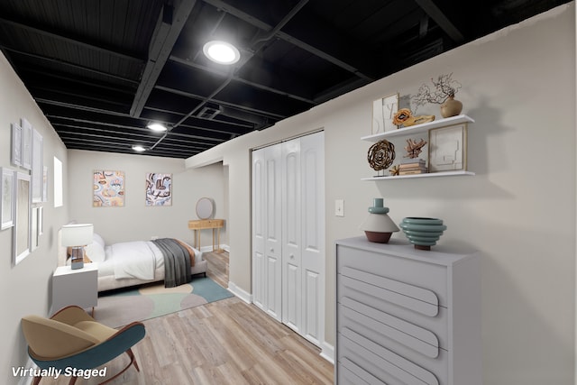 bedroom featuring light wood-type flooring and a closet