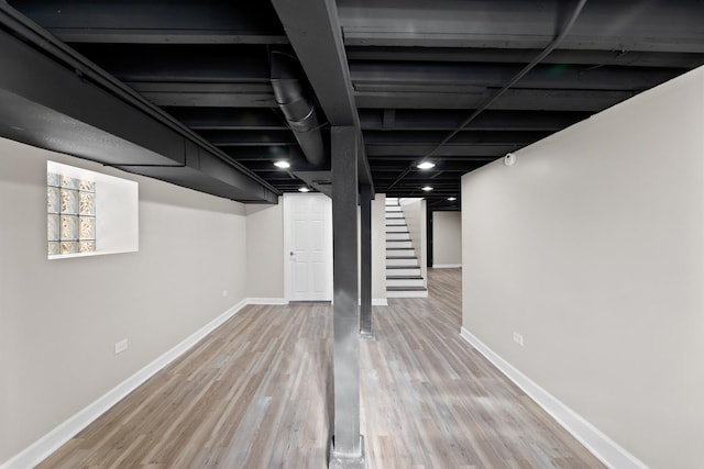 basement with hardwood / wood-style flooring