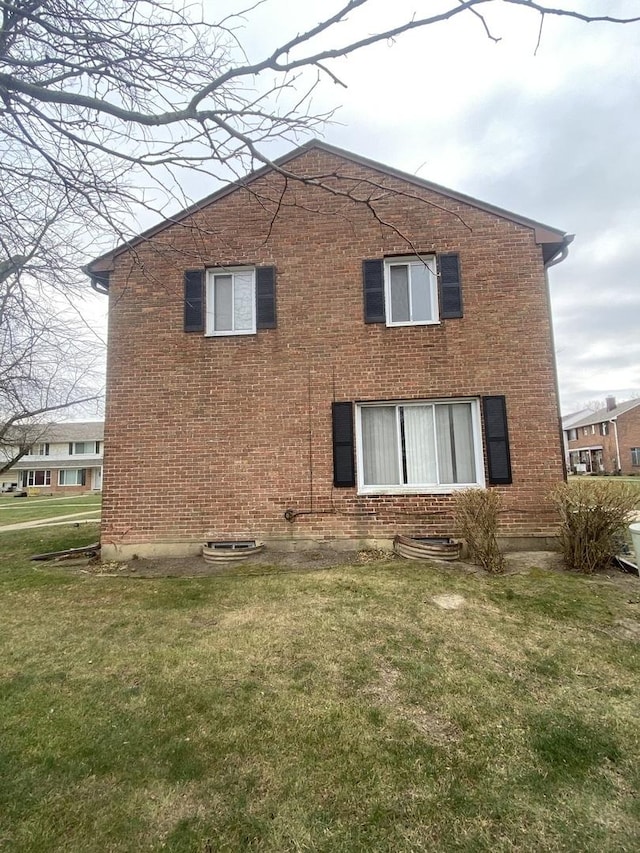 rear view of property featuring a yard