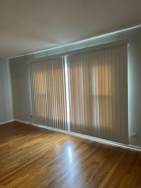 spare room featuring hardwood / wood-style floors