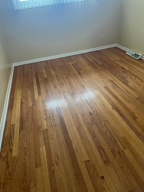 unfurnished room with wood-type flooring