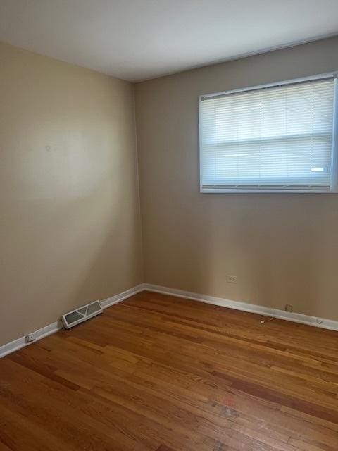 spare room featuring hardwood / wood-style floors