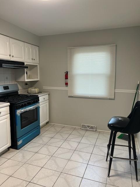 kitchen featuring white cabinetry and stainless steel gas range