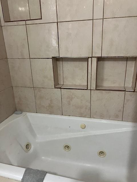 bathroom featuring a relaxing tiled tub