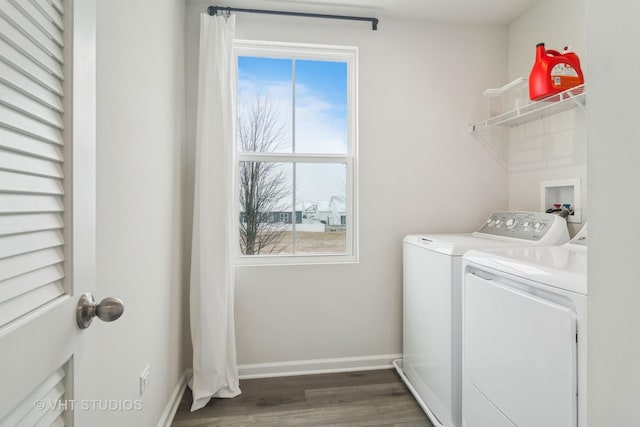 laundry area with separate washer and dryer, dark wood-type flooring, and plenty of natural light