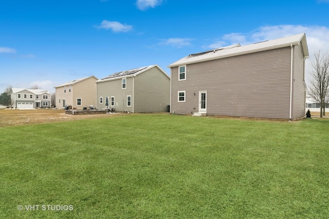 rear view of property with a yard