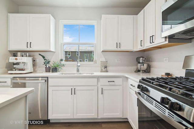 kitchen featuring sink, stainless steel appliances, and white cabinetry