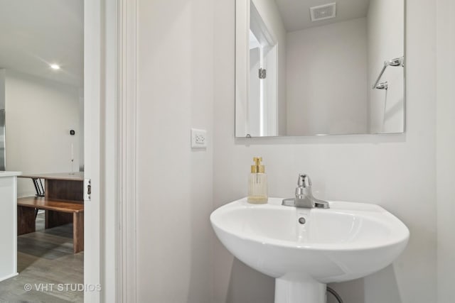 bathroom featuring sink and hardwood / wood-style floors